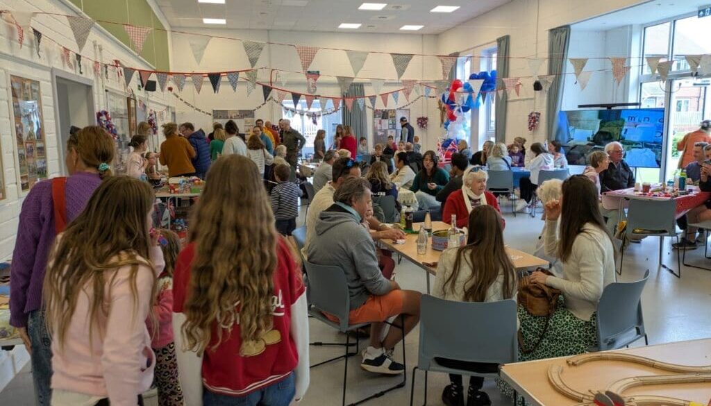 A crowd of party guests at the VE Day 80 celebrations.