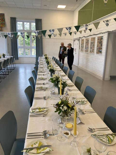 A catered meal for sixty guests with a soft yellow, green and cream palette that perfectly complements the rural setting.